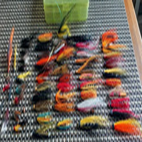 LURE BOX FULL OF ASSORTED TUBE FLIES .