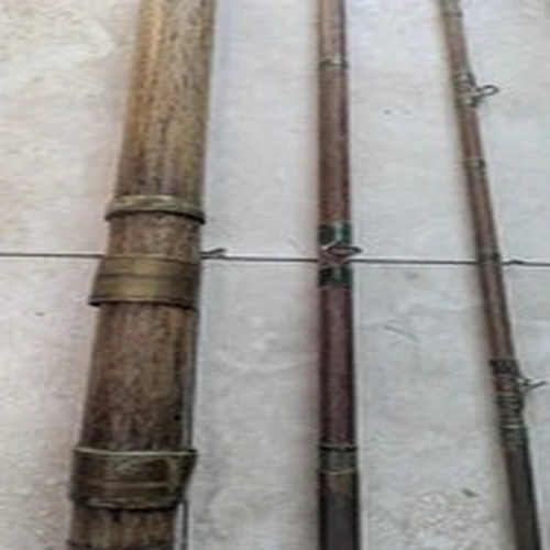 This is a vintage multi-piece split cane fishing rod featuring a wooden handle,