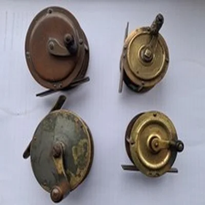 Four small brass decorative old fishing reels for angling display.