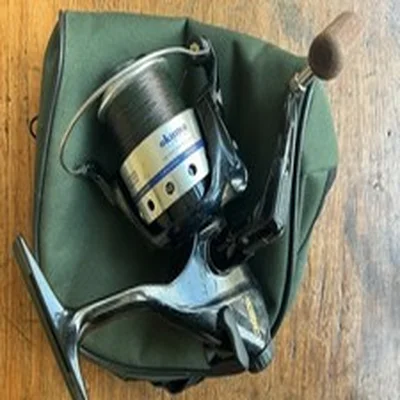 Okuma Longbow L B 50 fishing reel with a spool full of line and a storage pouch