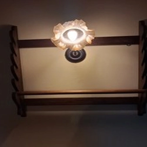 Fishing rod and reel display rack in english oak with carved fish motifs on side